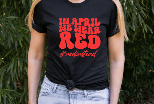 In April we wear red #redinstead Autism acceptance black t shirt